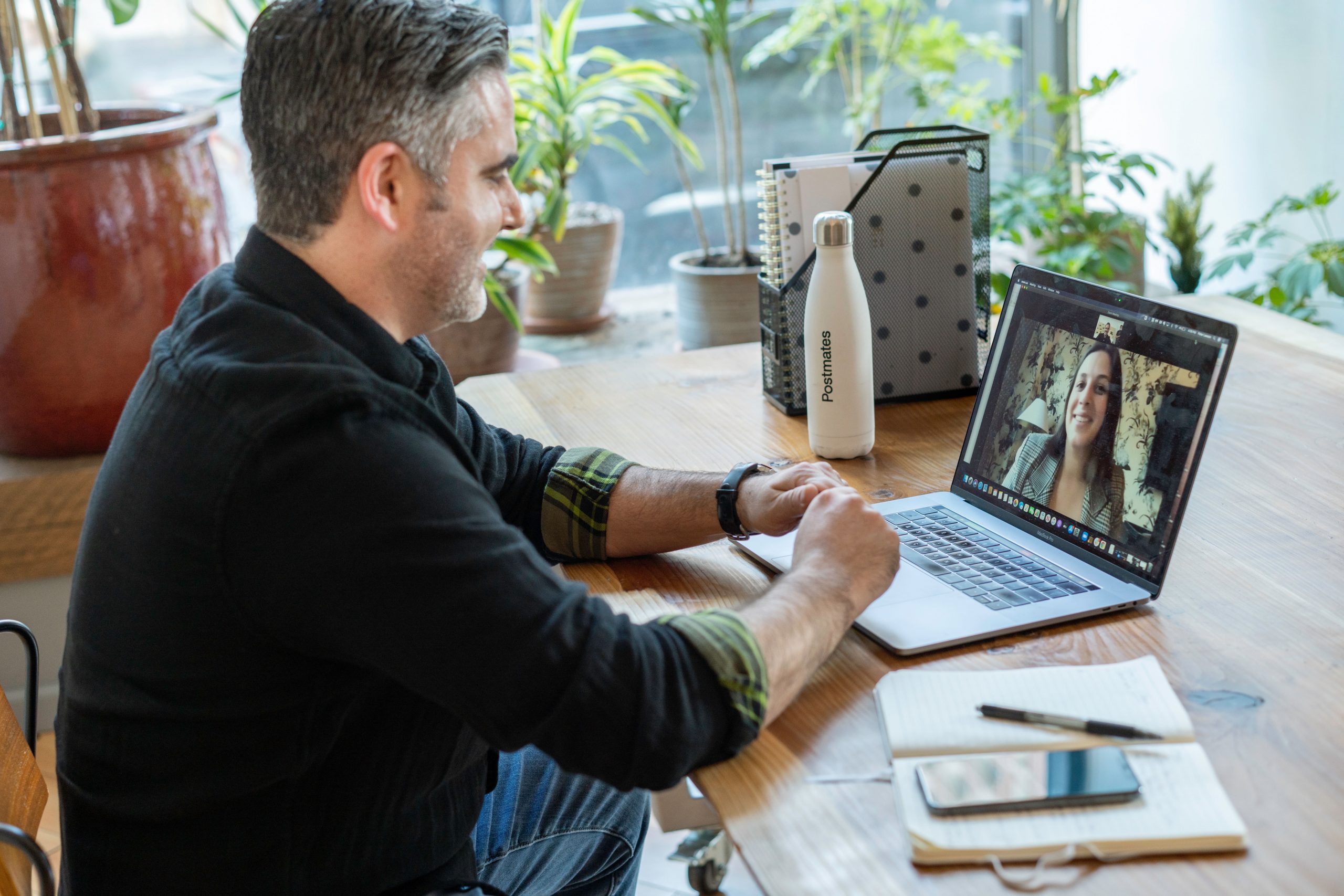 Professional working on laptop at desk in modern office environment