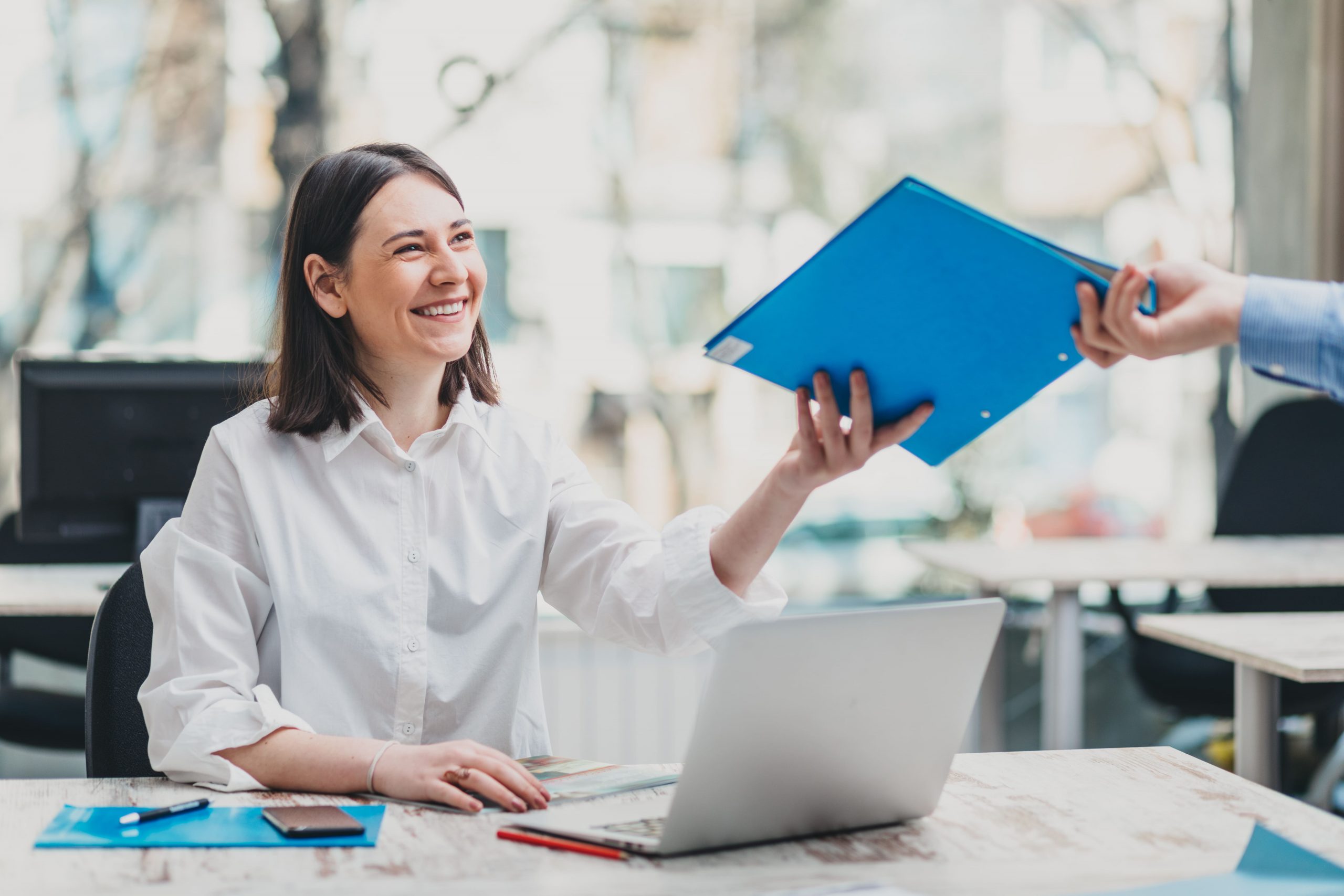 A women handing over some documents as she is reliable