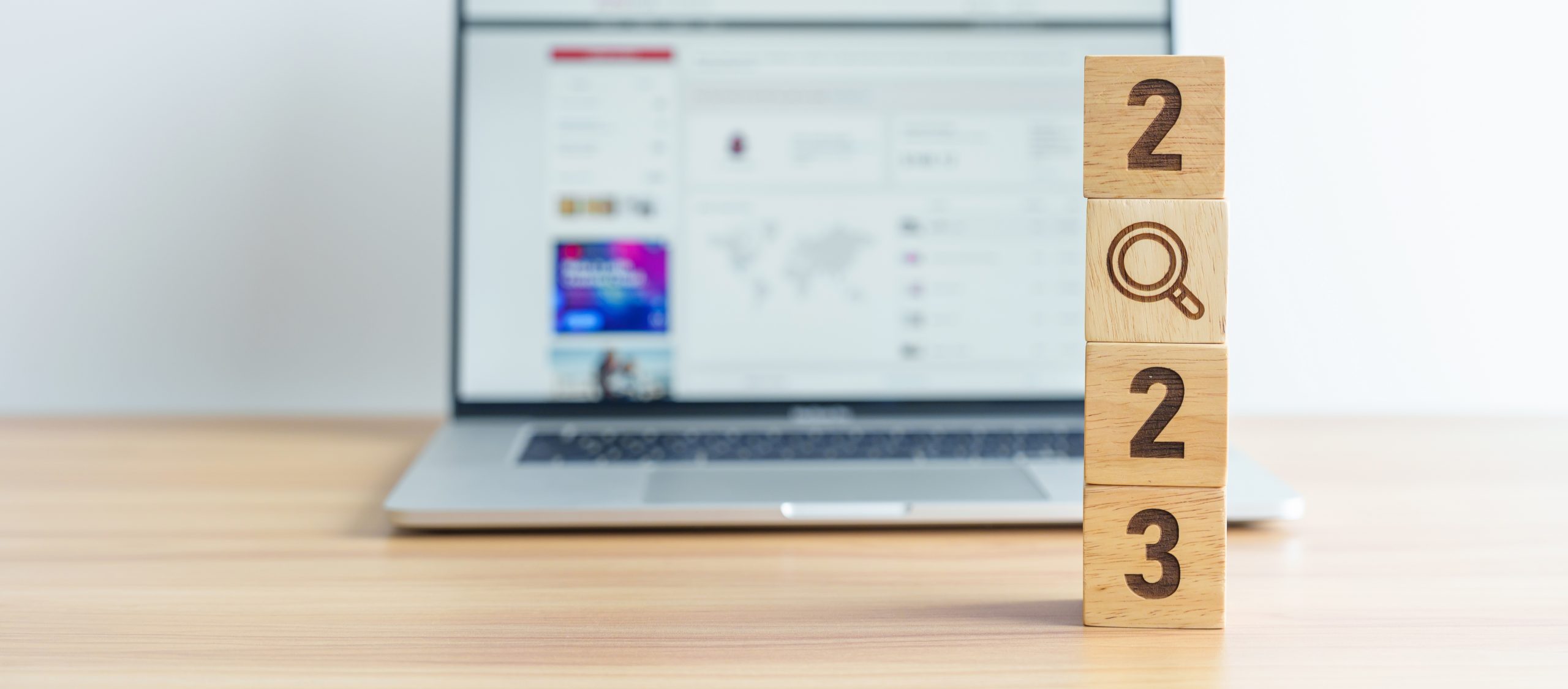 Wooden blocks saying '2023', with the '0' as a magnifying glass to explore what recruitment looks like in 2023